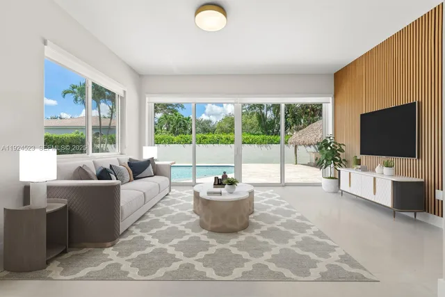 a view of an empty room with wooden floor and windows