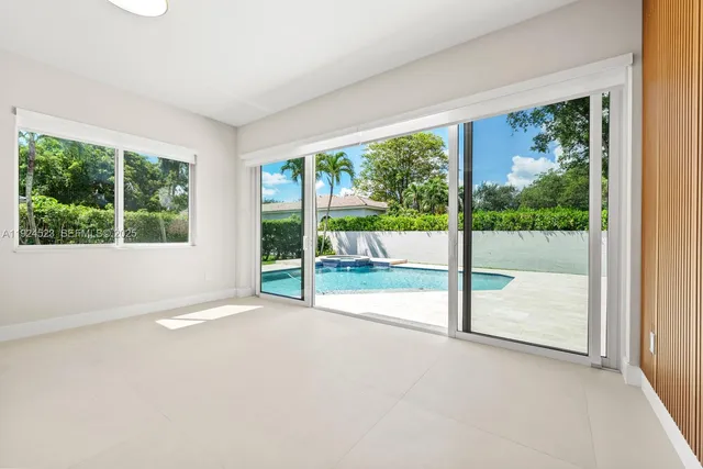 a bedroom with a large bed and a flat screen tv