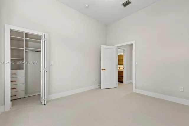a bathroom with a sink a toilet and a large mirror