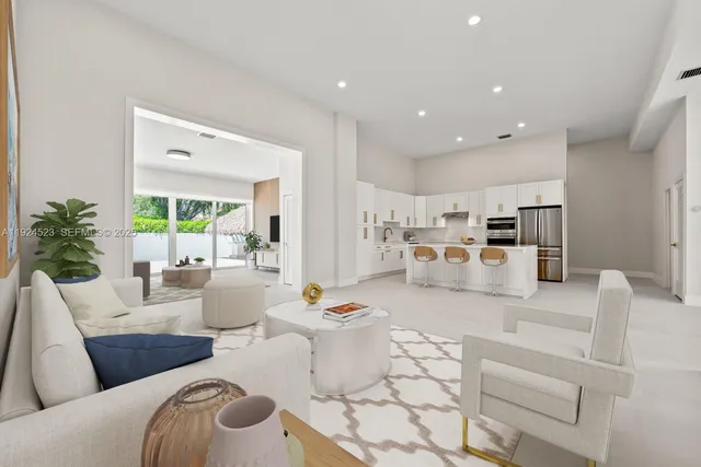 a living room with furniture and kitchen view