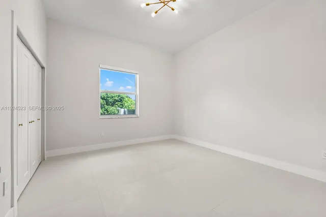 an empty room with closet area