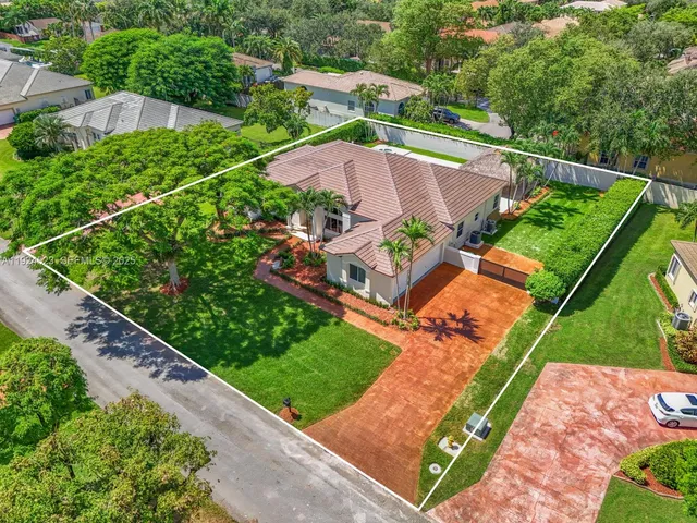 an aerial view of a house with a garden and yard