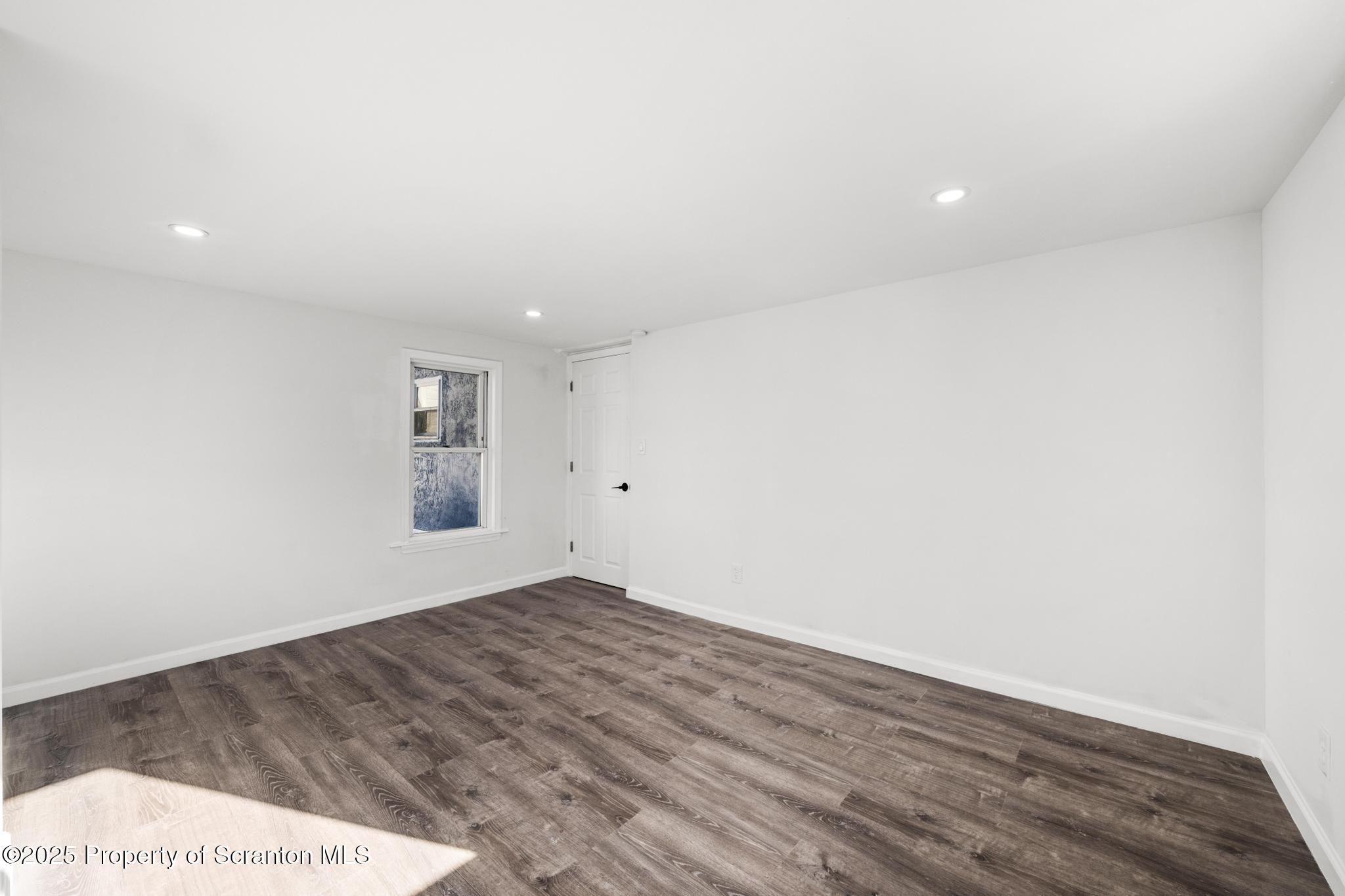949 Taylor Avenue Scranton, PA 18510 - Photo 16 of 46 an empty room with wooden floor and windows