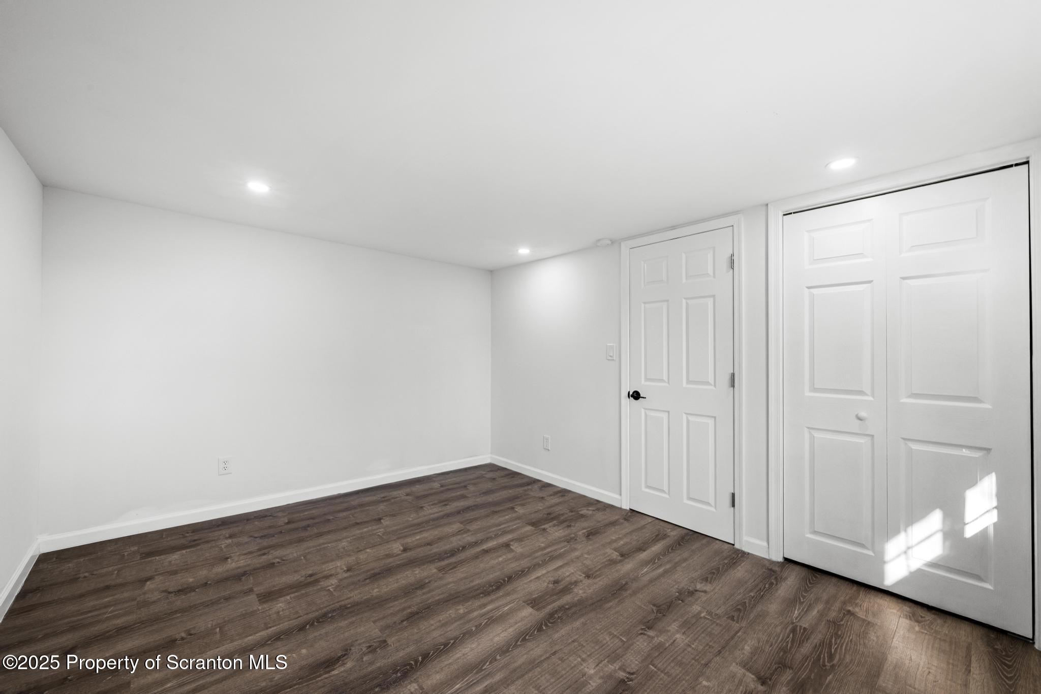 949 Taylor Avenue Scranton, PA 18510 - Photo 19 of 46 a view of an empty room with wooden floor