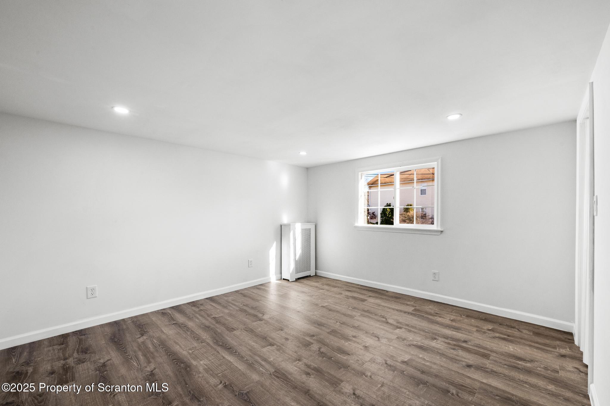 949 Taylor Avenue Scranton, PA 18510 - Photo 20 of 46 an empty room with wooden floor and window