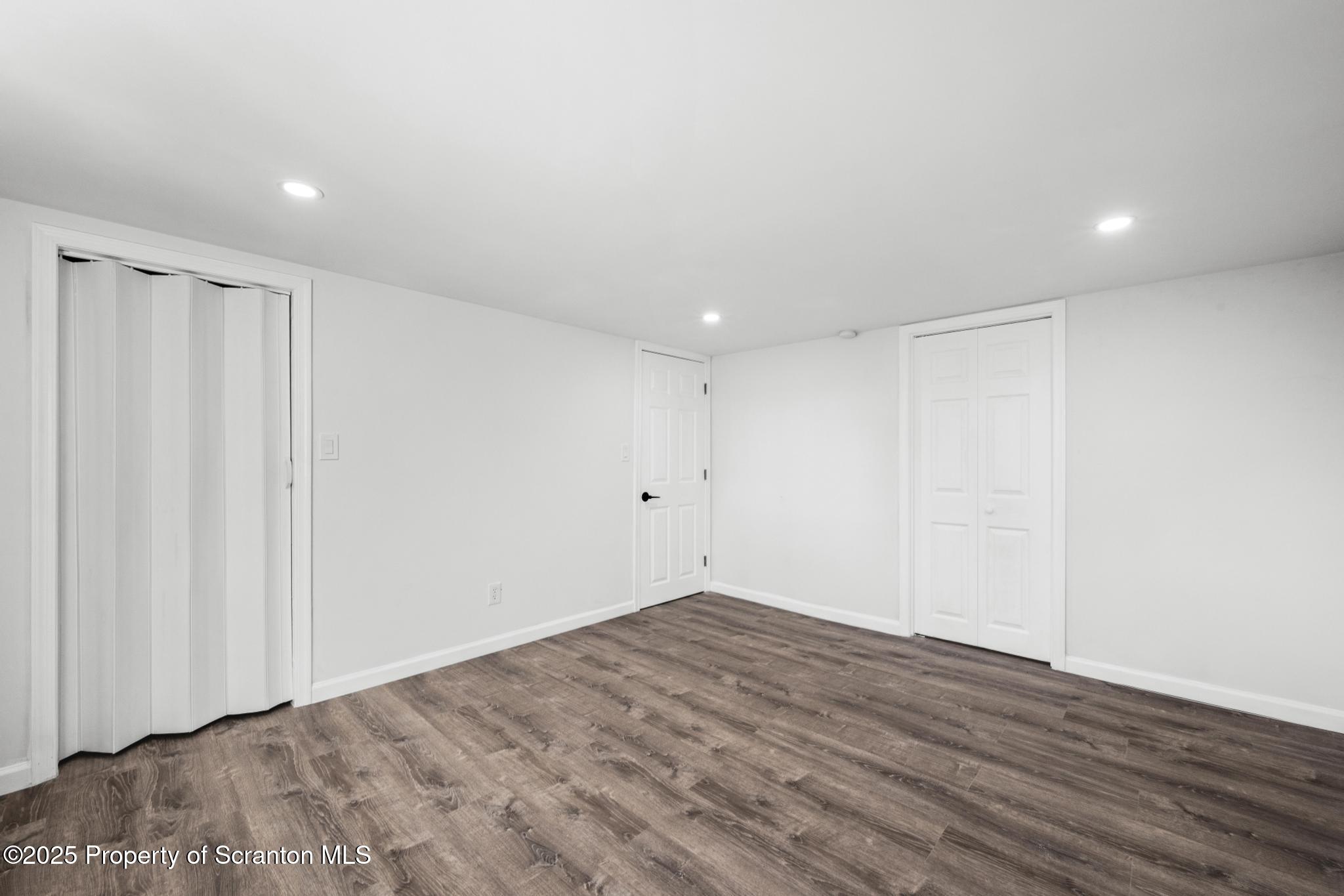 949 Taylor Avenue Scranton, PA 18510 - Photo 21 of 46 a view of a room with wooden floor and white walls