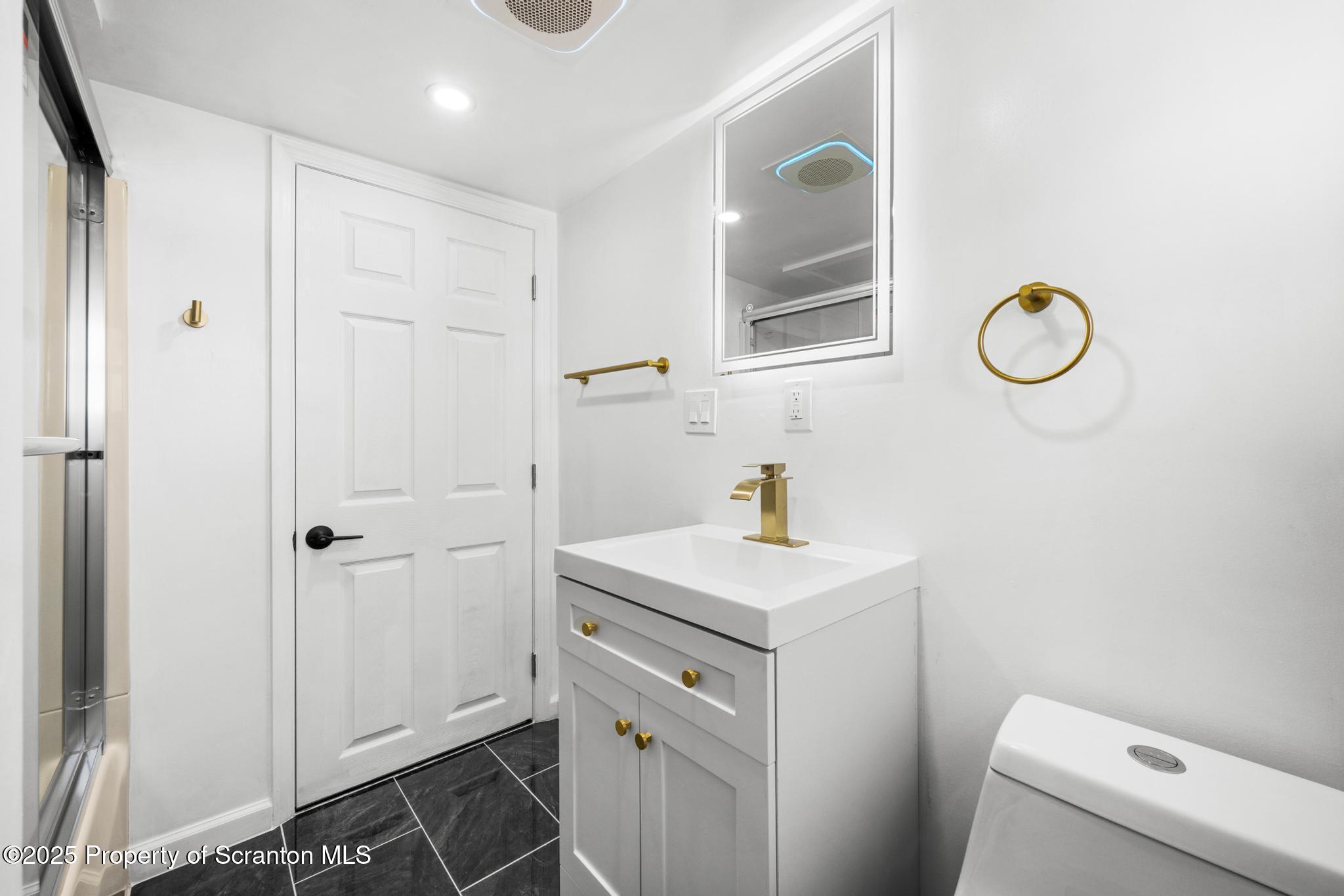 949 Taylor Avenue Scranton, PA 18510 - Photo 24 of 46 a bathroom with a sink a toilet and a mirror