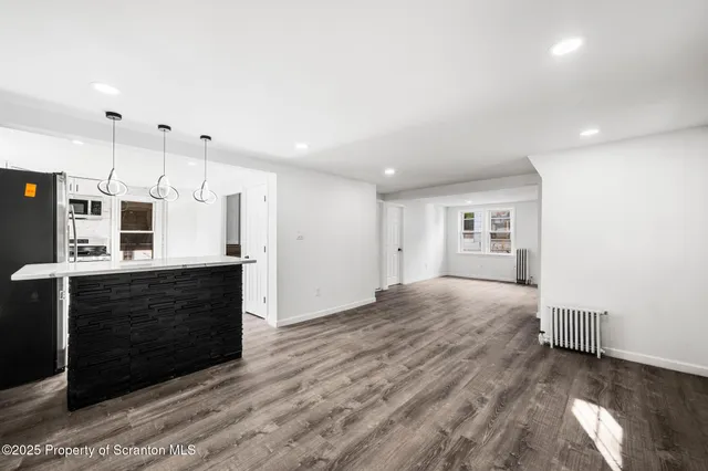 a view of kitchen with wooden floor and electronic appliances