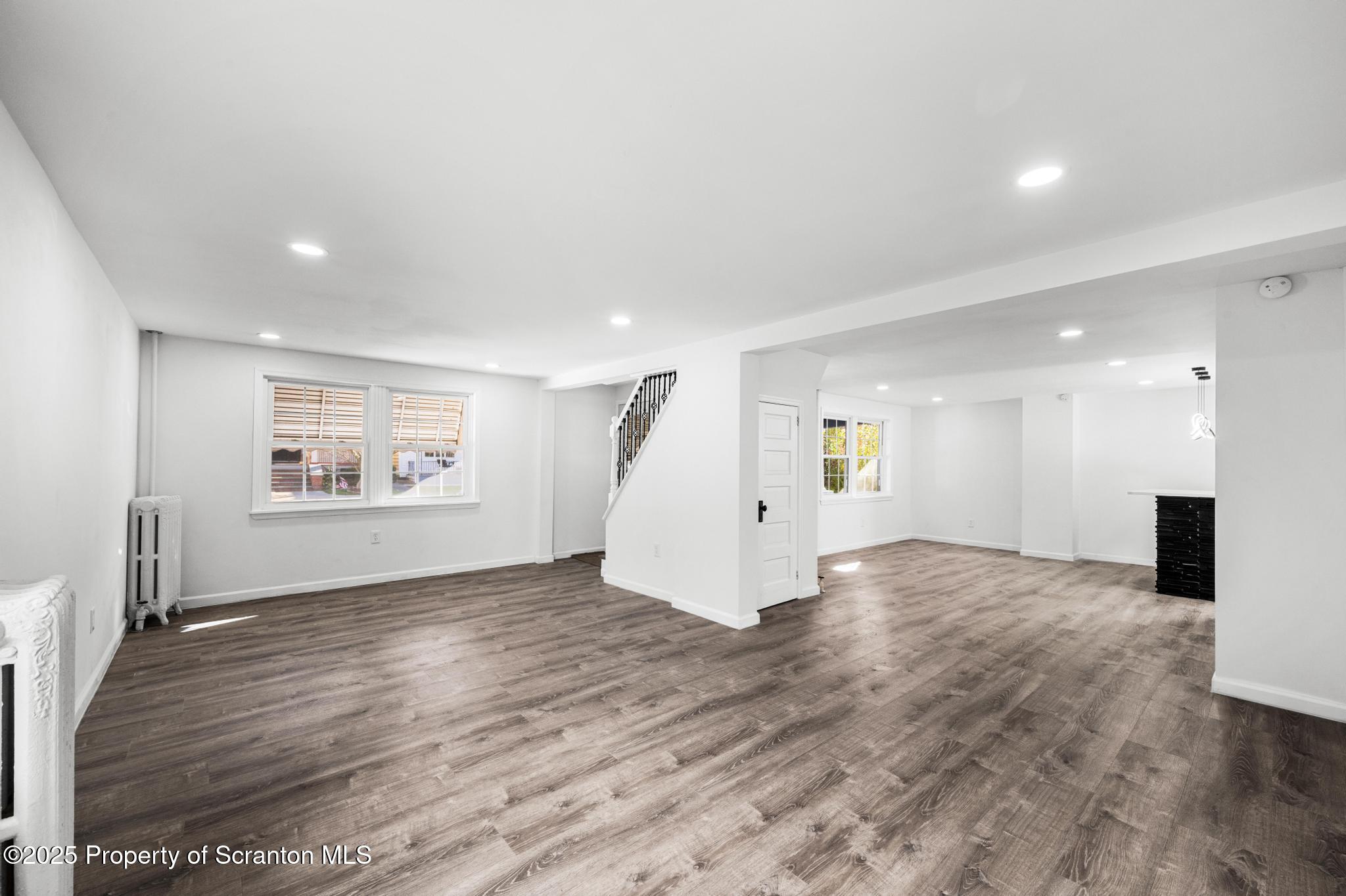 949 Taylor Avenue Scranton, PA 18510 - Photo 28 of 46 an empty room with wooden floor and windows
