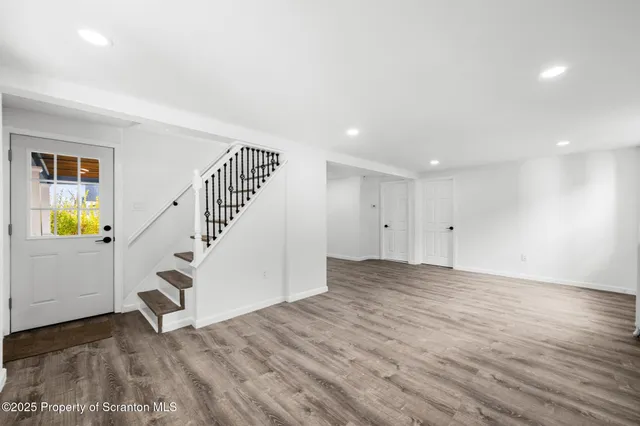a view of an entryway with wooden floor