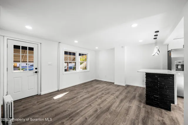 wooden floor in an empty room with a fireplace