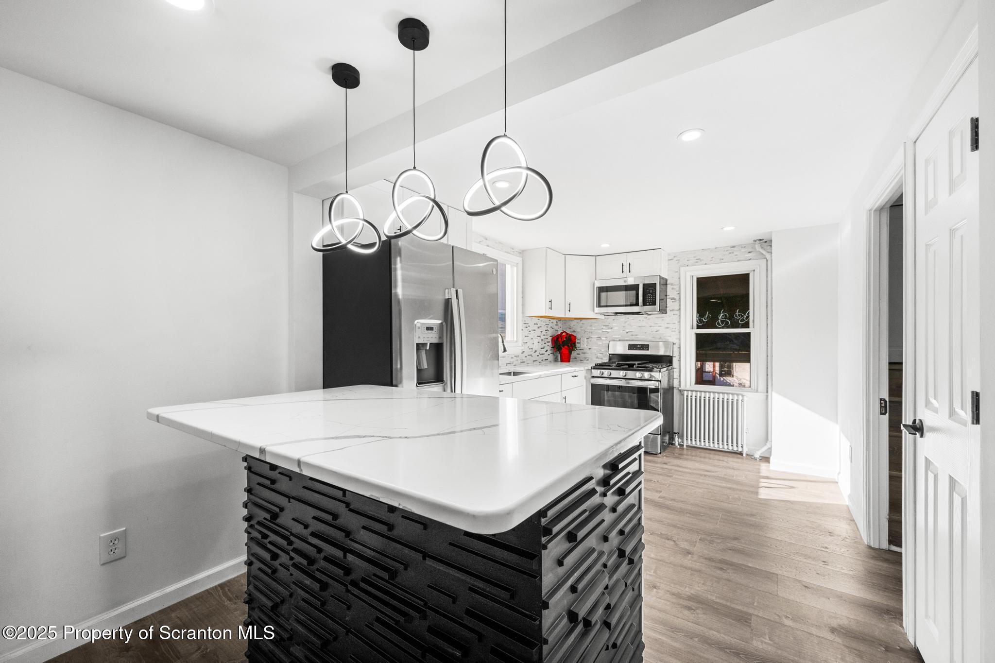 949 Taylor Avenue Scranton, PA 18510 - Photo 31 of 46 a kitchen with a table chairs and wooden floor