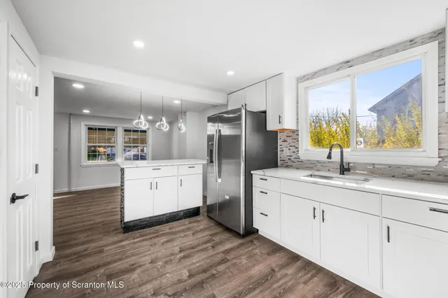 a kitchen with a sink stainless steel appliances and cabinets