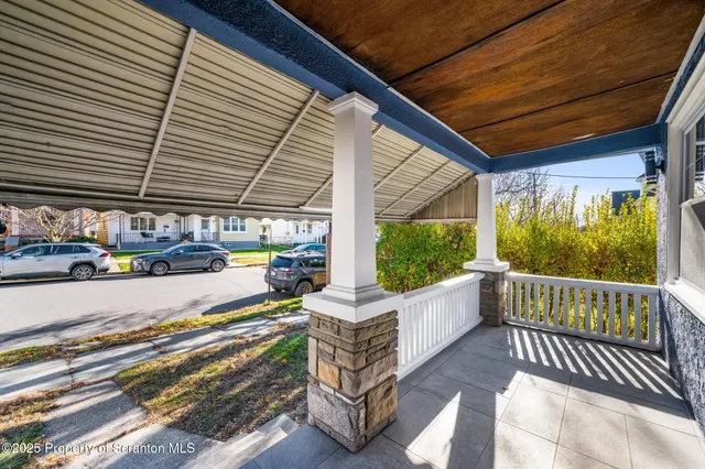 a front view of a house with garden and patio