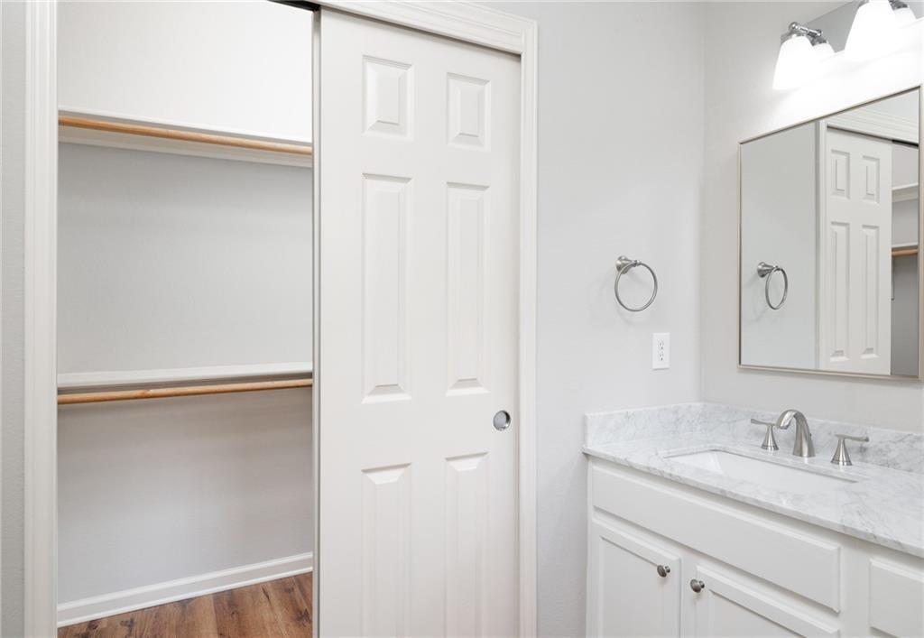 4526 Corran Ferry Loop Austin, TX 78749 - Photo 19 of 25 Stone counters and a built-in closet maximize space in this modern bathroom.