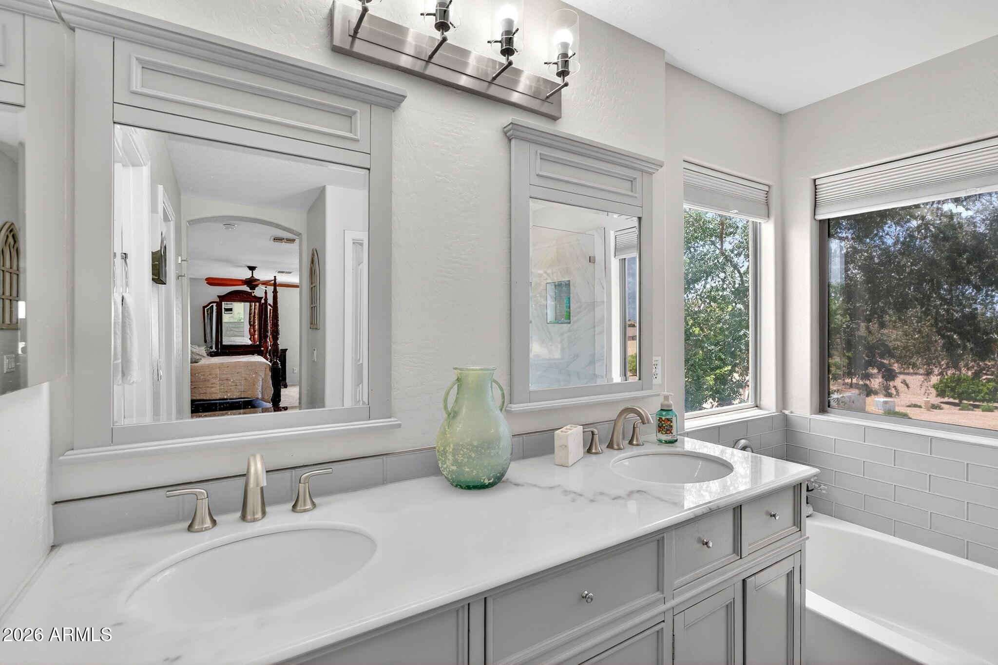 6280 South Sinova Court Gilbert, AZ 85298 - Photo 37 of 64 a bathroom with double vanity sinks a large mirror and a window