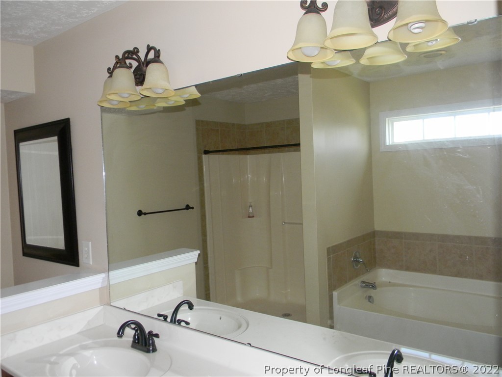 122 Middle Court Raeford, NC 28376 - Photo 11 of 23 a bathroom with a sink and a mirror