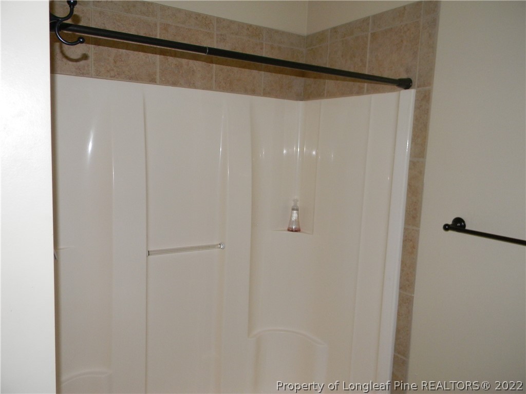 122 Middle Court Raeford, NC 28376 - Photo 12 of 23 a bathroom with a glass shower door