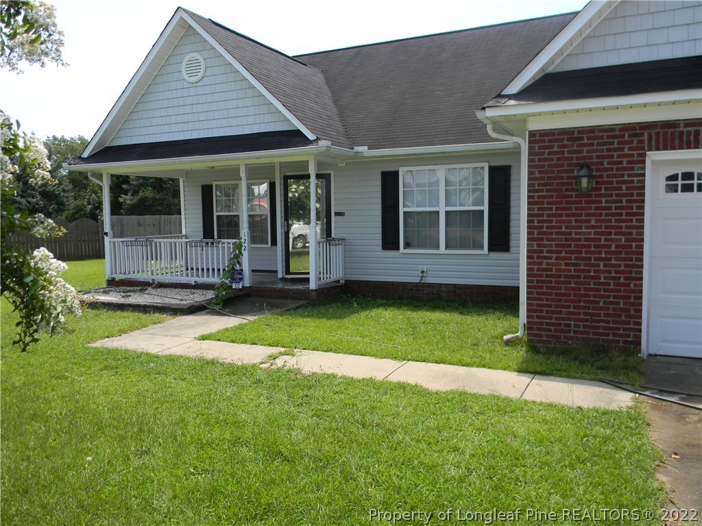 122 Middle Court Raeford, NC 28376 - Photo 2 of 23 a view of a house with a garden and yard