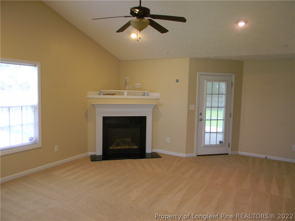 122 Middle Court Raeford, NC 28376 - Photo 3 of 23 a view of empty room with a fireplace and fan