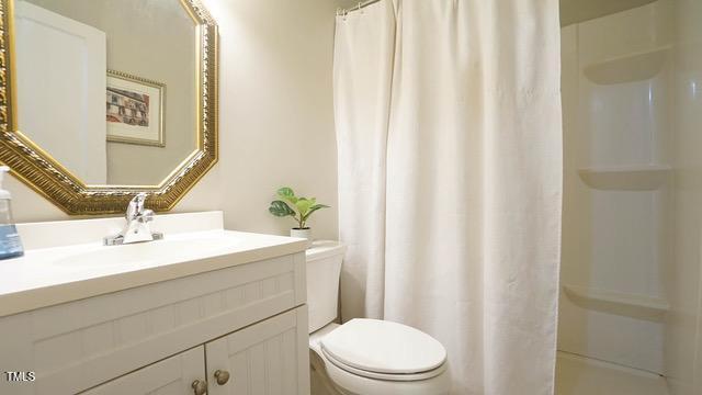 700 Glascock Street Raleigh, NC 27604 - Photo 12 of 21 a bathroom with a sink a toilet and shower curtain