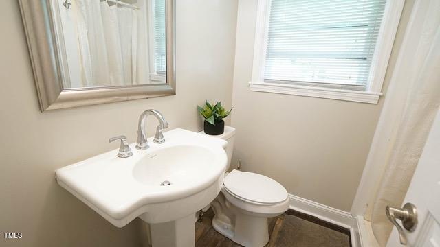 700 Glascock Street Raleigh, NC 27604 - Photo 13 of 21 a bathroom with a sink a toilet and a mirror