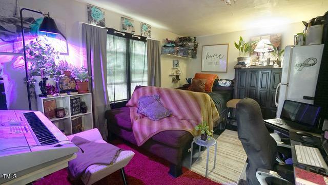 700 Glascock Street Raleigh, NC 27604 - Photo 16 of 21 a bedroom with furniture and a flat screen tv