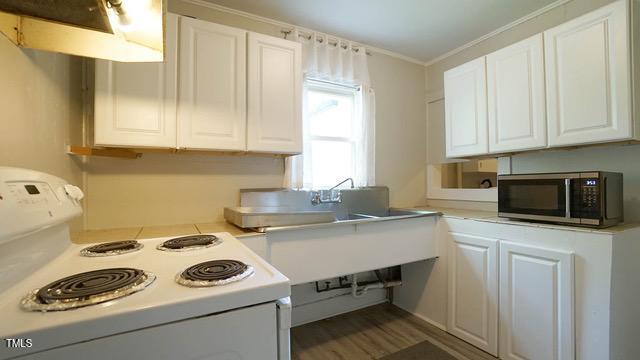 700 Glascock Street Raleigh, NC 27604 - Photo 6 of 21 a kitchen with a sink a stove and cabinets