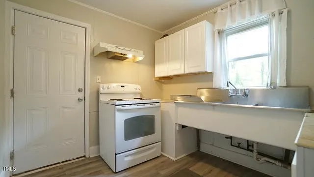 a kitchen with a stove cabinets and a sink