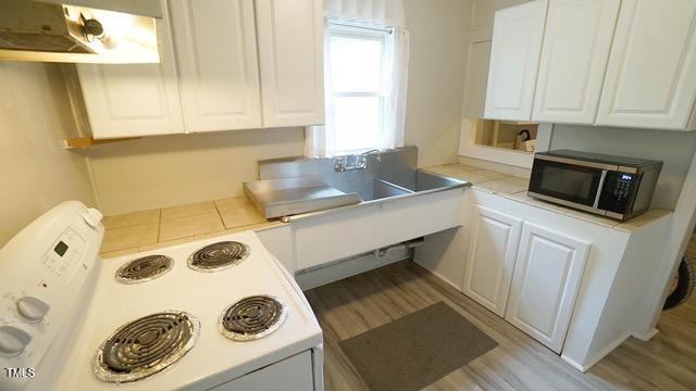 700 Glascock Street Raleigh, NC 27604 - Photo 8 of 21 a kitchen with a sink a stove and cabinets