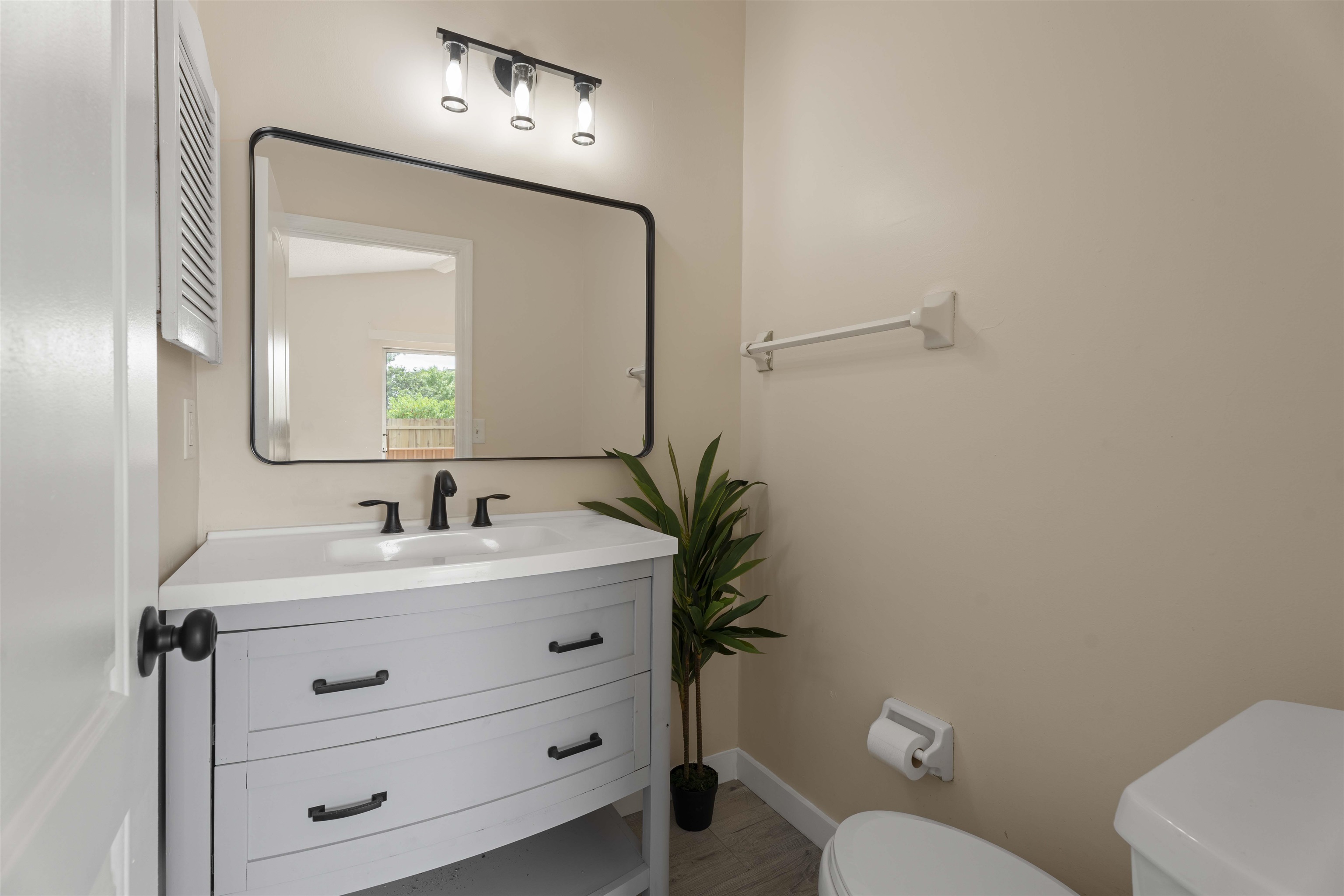 207 B Street St. Augustine Beach, FL 32080 - Photo 13 of 22 a bathroom with a toilet sink and mirror
