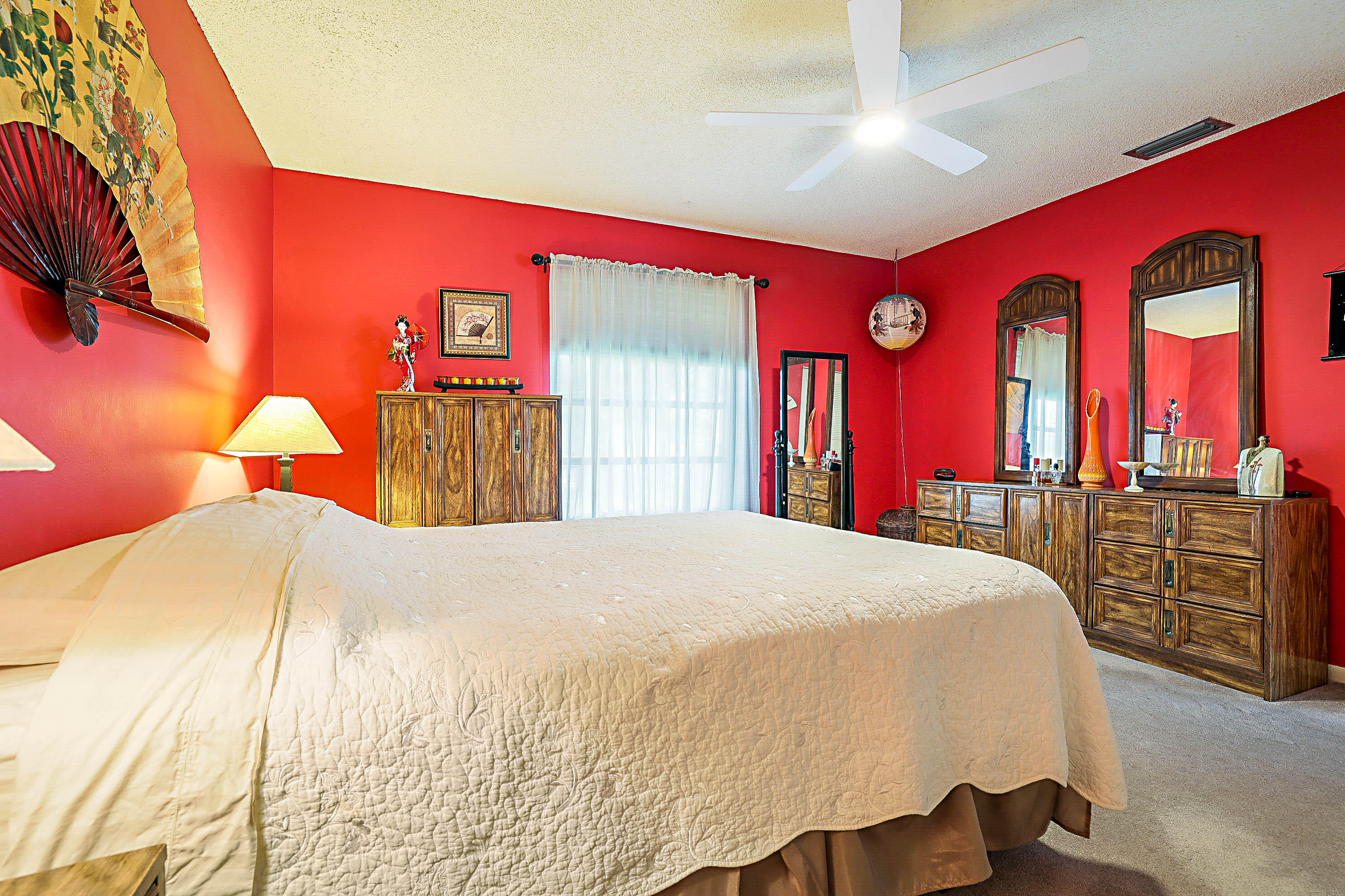 5231 Copperleaf Circle Delray Beach, FL 33484 - Photo 18 of 31 a bedroom with a bed and dresser with mirror