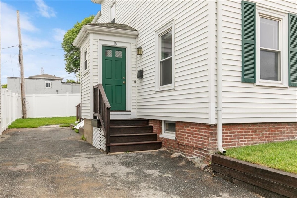 16 Rantoul Street Beverly, MA 01915 - Photo 4 of 34 a view of a house with a small yard and wooden fence