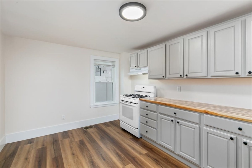16 Rantoul Street Beverly, MA 01915 - Photo 10 of 34 a kitchen with white cabinets and sink