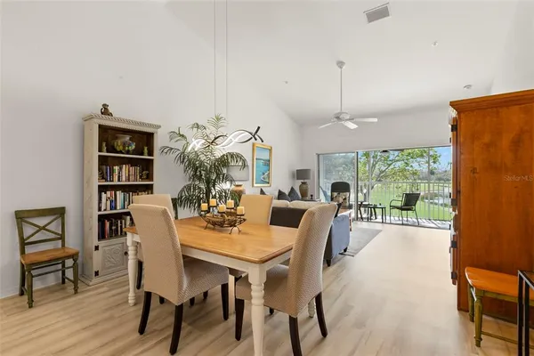a dining room with furniture a window and wooden floor