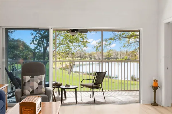 a living room with furniture and a floor to ceiling window
