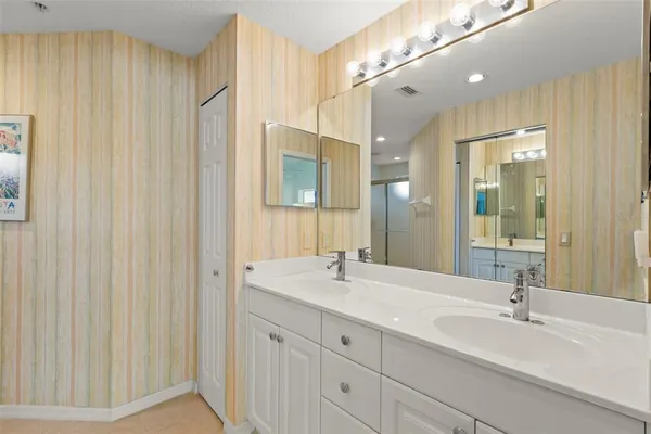 a bathroom with a double vanity sink and a mirror