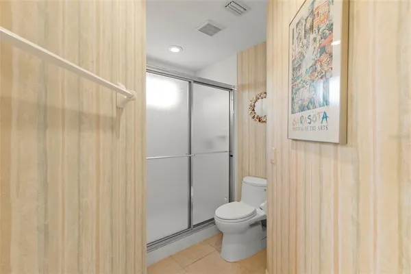 a bathroom with a toilet and a shower