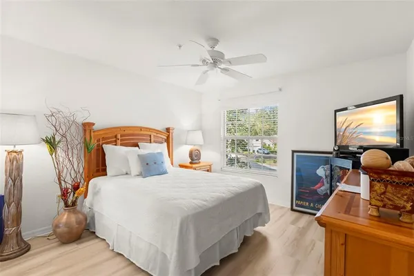 a bedroom with a bed and wooden floor