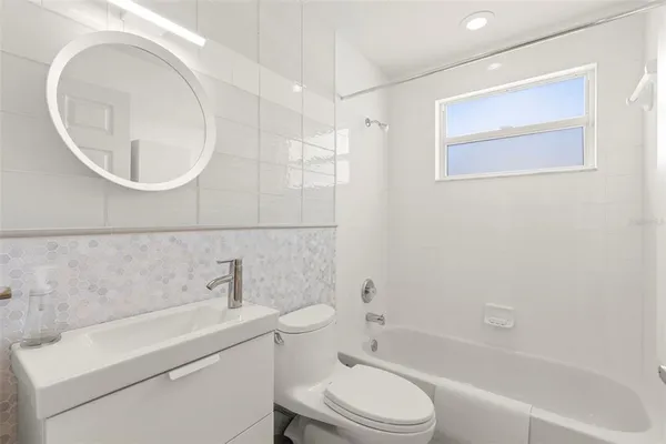 a bathroom with a toilet a sink and bathtub