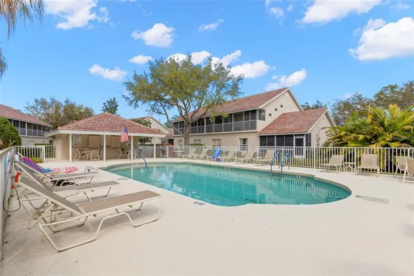a swimming pool with outdoor seating yard and barbeque oven