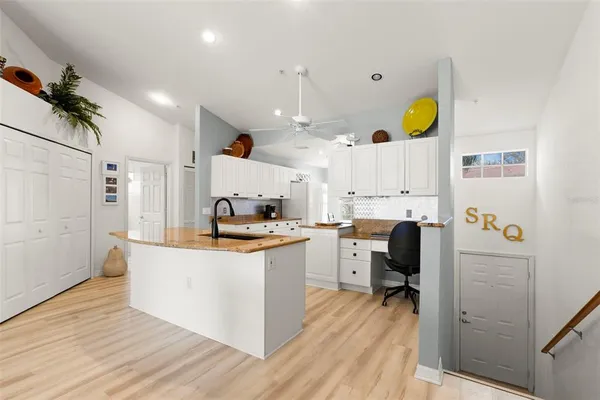 a kitchen with a sink appliances and cabinets