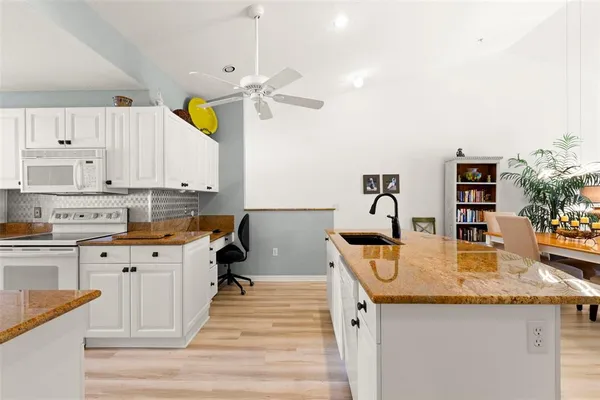 a kitchen with counter top space appliances and cabinets