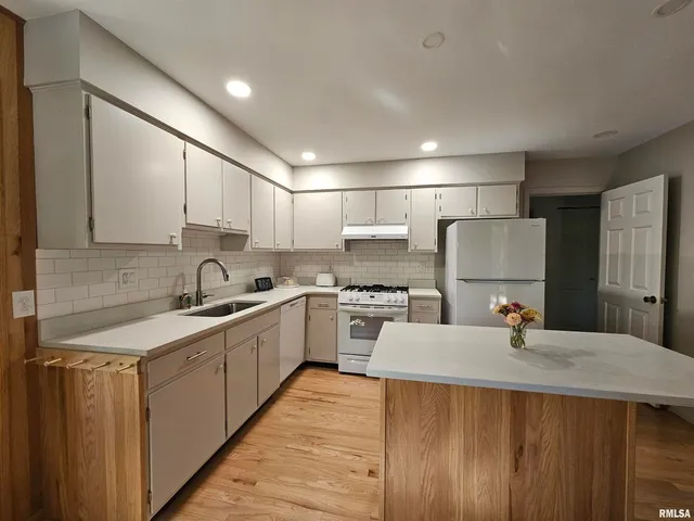 a kitchen with a sink stove and refrigerator