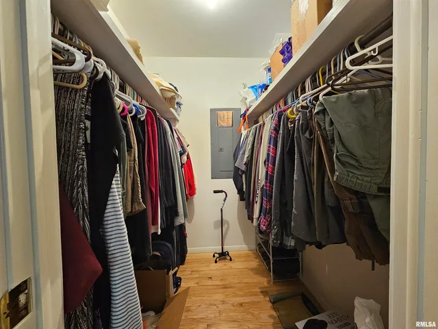 a view of walk in closet with clothes and shoes