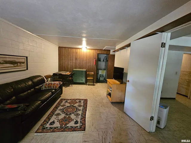 a living room with a couch and a refrigerator