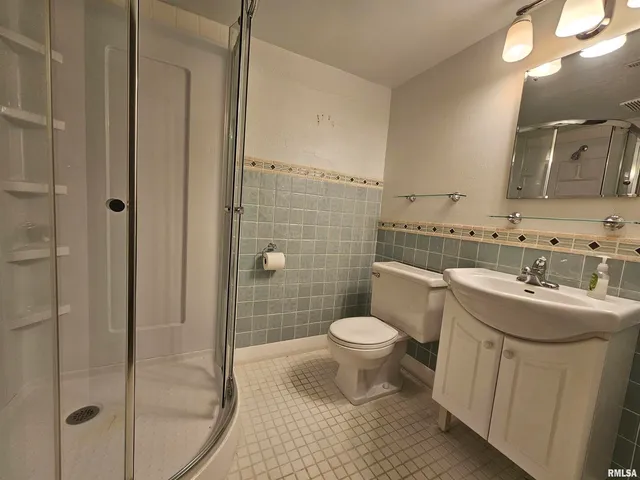 a bathroom with a sink toilet a mirror and shower