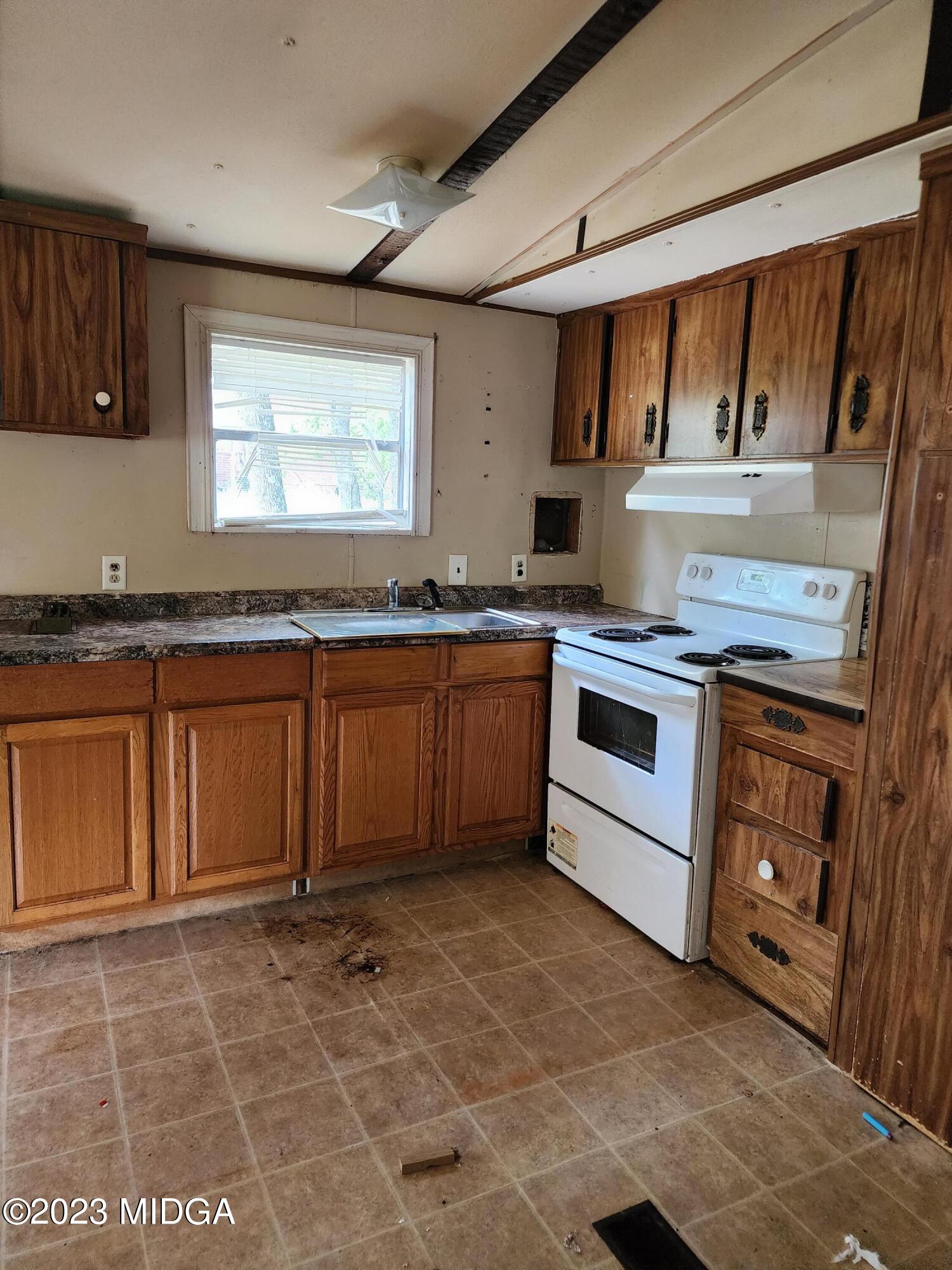 3531 Baker Road Macon, GA 31211 - Photo 5 of 21 a kitchen with a stove sink and cabinets