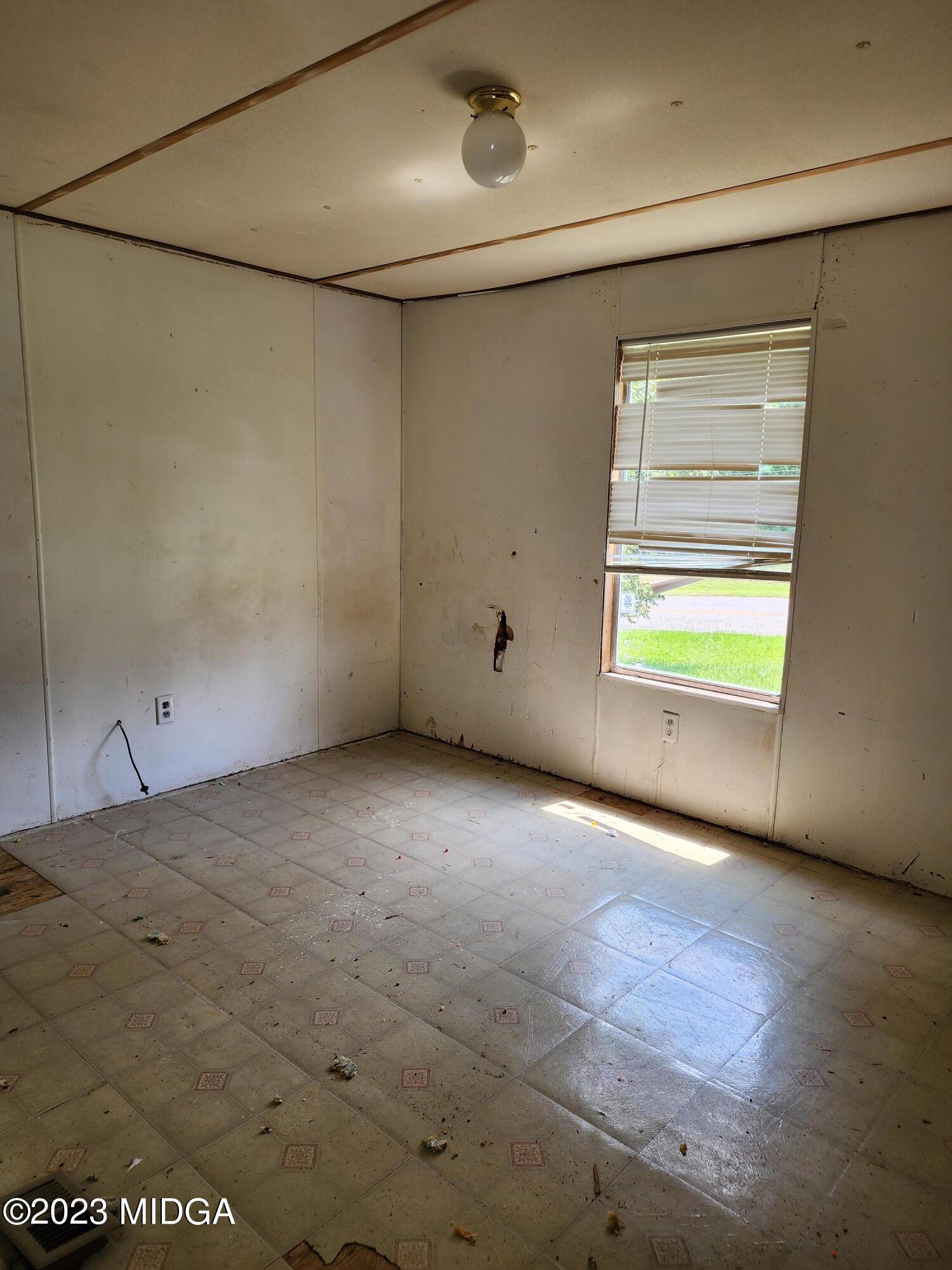3531 Baker Road Macon, GA 31211 - Photo 7 of 21 a view of an empty room with a window
