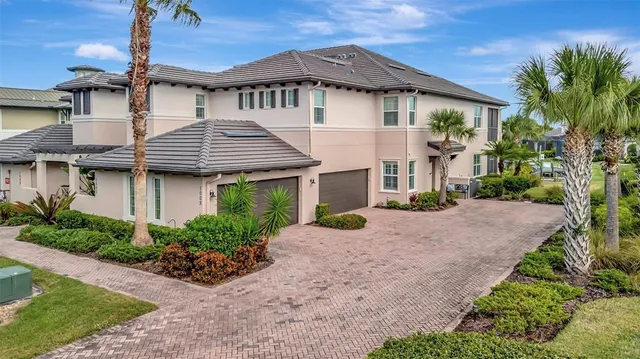 a front view of a house with a garden and plants